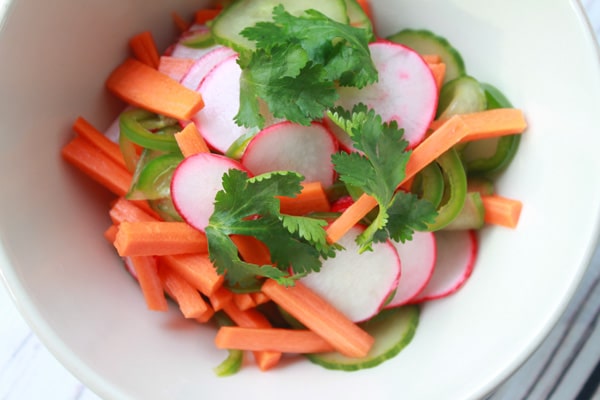 a bowl of fresh pickled vegetables topped with cilantro