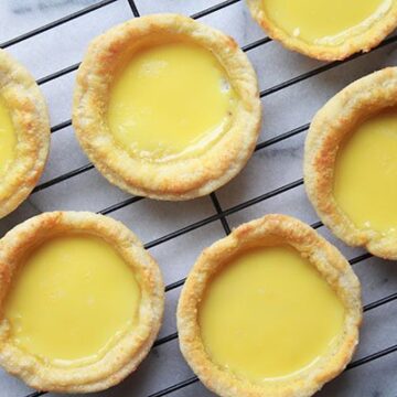 Chinese egg custard tarts on a cooling rack