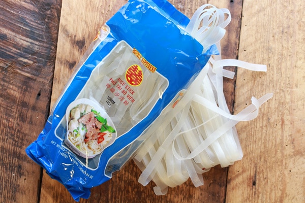 Asian rice noodles in the package on a top of a wooden board