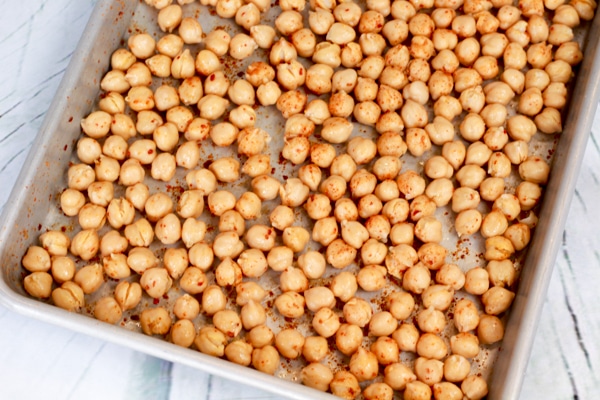 spiced chickpeas on baking tray ready for the oven.