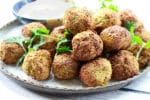 air-fried falafel balls on a plate with a side of spicy aioli dipping sauce
