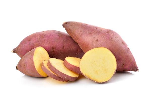 white sweet potatoes sliced on a white background