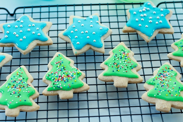 glazed and decorated holiday sugar cookies on top of a cooling rack