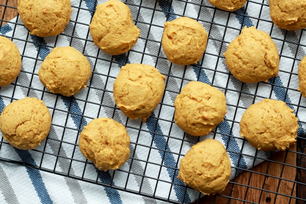 baked pumpkin spice cookies right out of the oven on top of a cooling rack