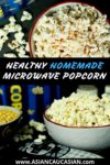 Two heaping bowls of homemade microwave popcorn with spice bottles behind.