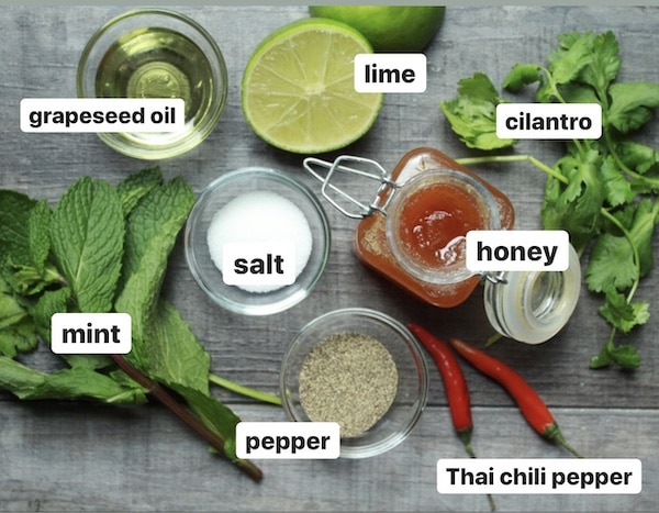 labeled ingredients for spicy mango and pineapple salad on a wooden board