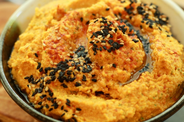 close-up of a bowl of roasted carrot and ginger hummus