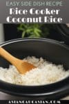 Coconut rice in a rice cooker with a wooden spoon