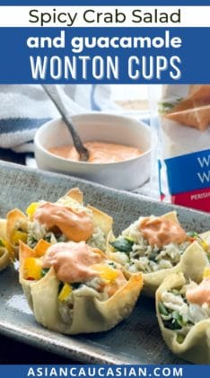 A gray serving platter with wonton cups filled with crab salad and a dollop of aioli on top with the package of wonton wrappers behind it.
