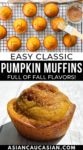 Freshly baked pumpkin muffins on a wire baking rack with a woman brushing the tops with butter.