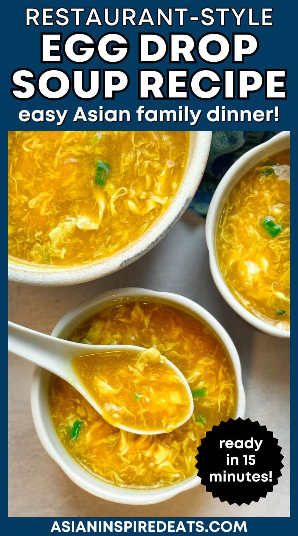Chinese egg drop soup in three bowls with a white spoon inserted into the front bowl on top of a gray surface with a blue napkin on the side.