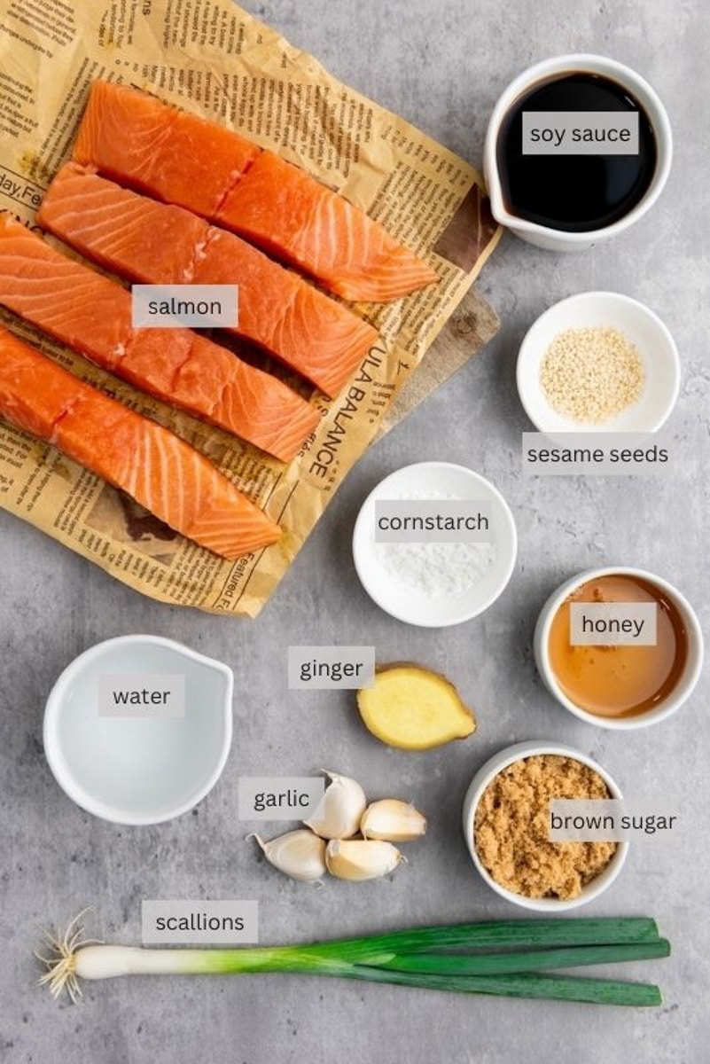 Labeled ingredients in small bowls for making Air Fryer Teriyaki Salmon on top of a gray surface.